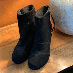 Woman’s black suede ankle boots